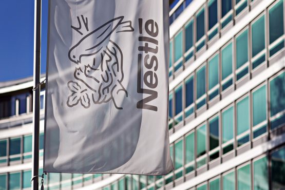 The company birds nest logo sits on a flag outside the Nestle SA headquarters in Vevey, Switzerland. Image: Michele Limina/Bloomberg